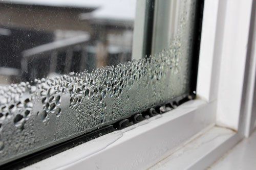 A close up of a window with water drops on it.