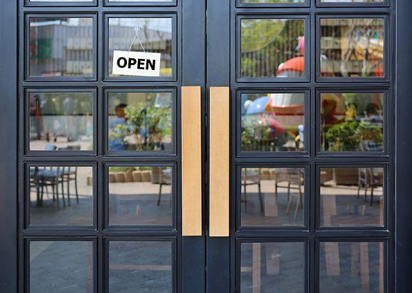 A restaurant with a sign on the door that says `` open ''.