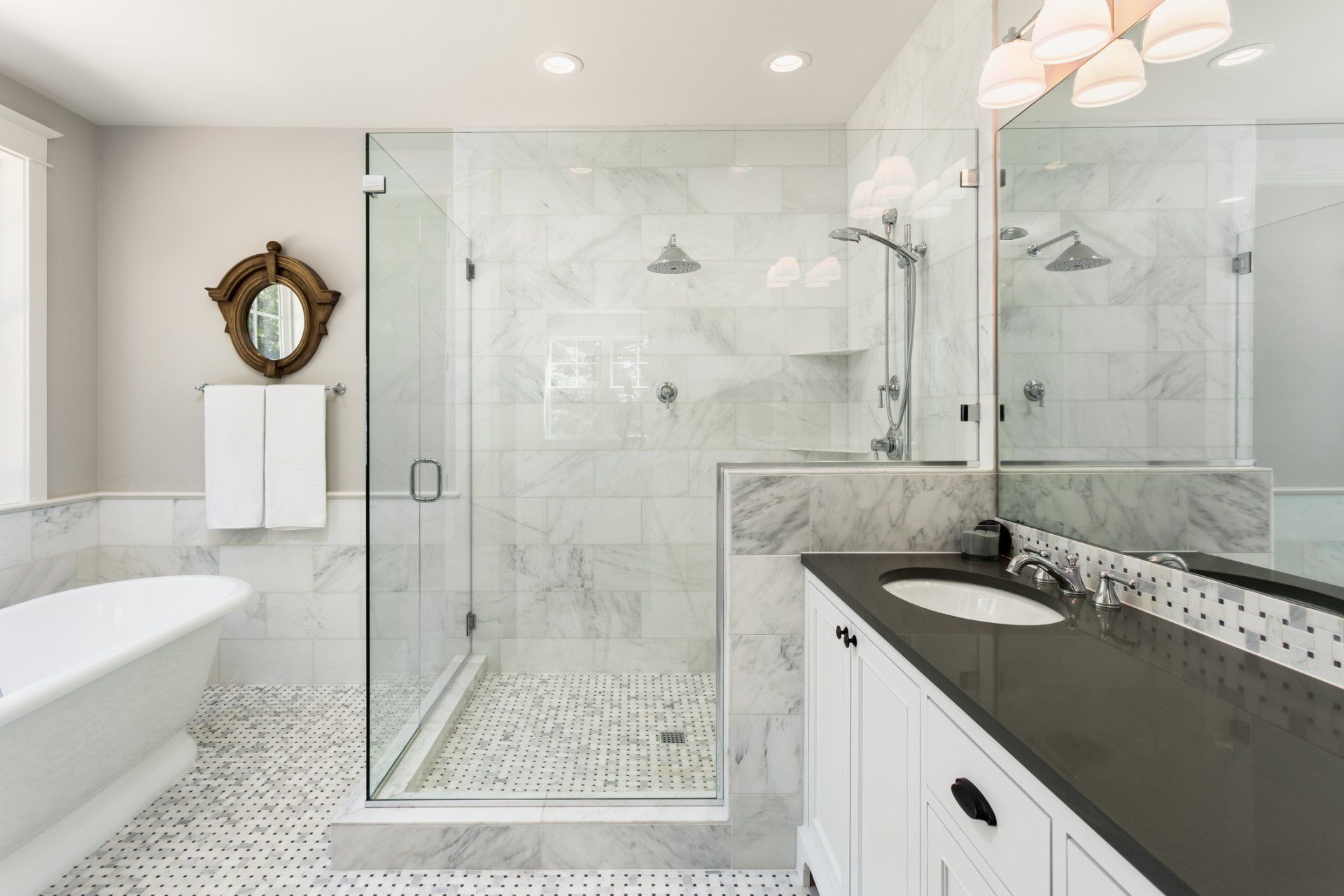 A bathroom with a bathtub , sink , shower and mirror.