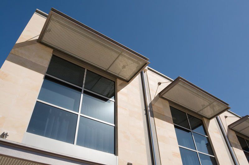 A building with a lot of windows and a blue sky in the background