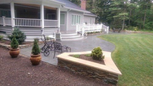 Patio with natural stone wall — Richmond, VA — Land Designs LLC