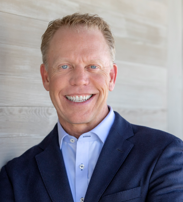 Man in blue blazer with light blue shirt and blonde hair