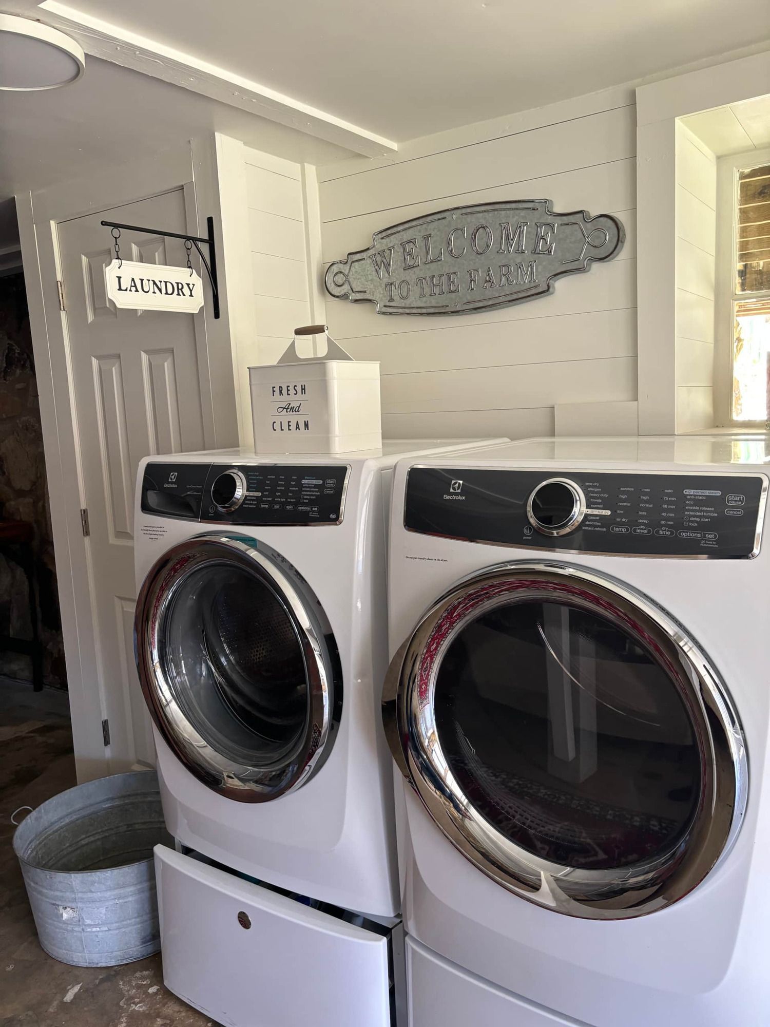 A washer and dryer are sitting next to each other in a laundry room.