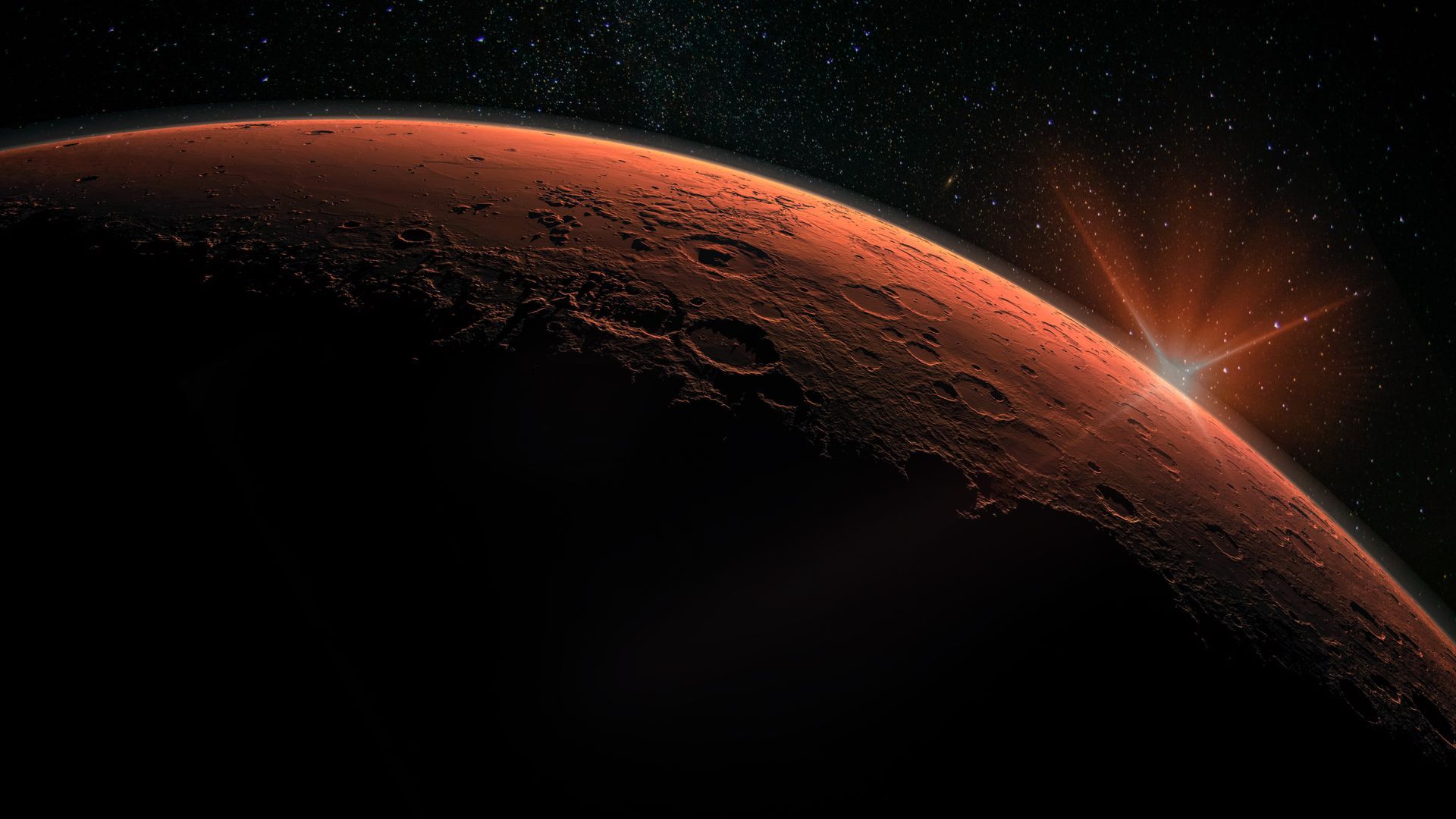 Mars, a reddish planet, with sunlight rising on the horizon against a starry background.