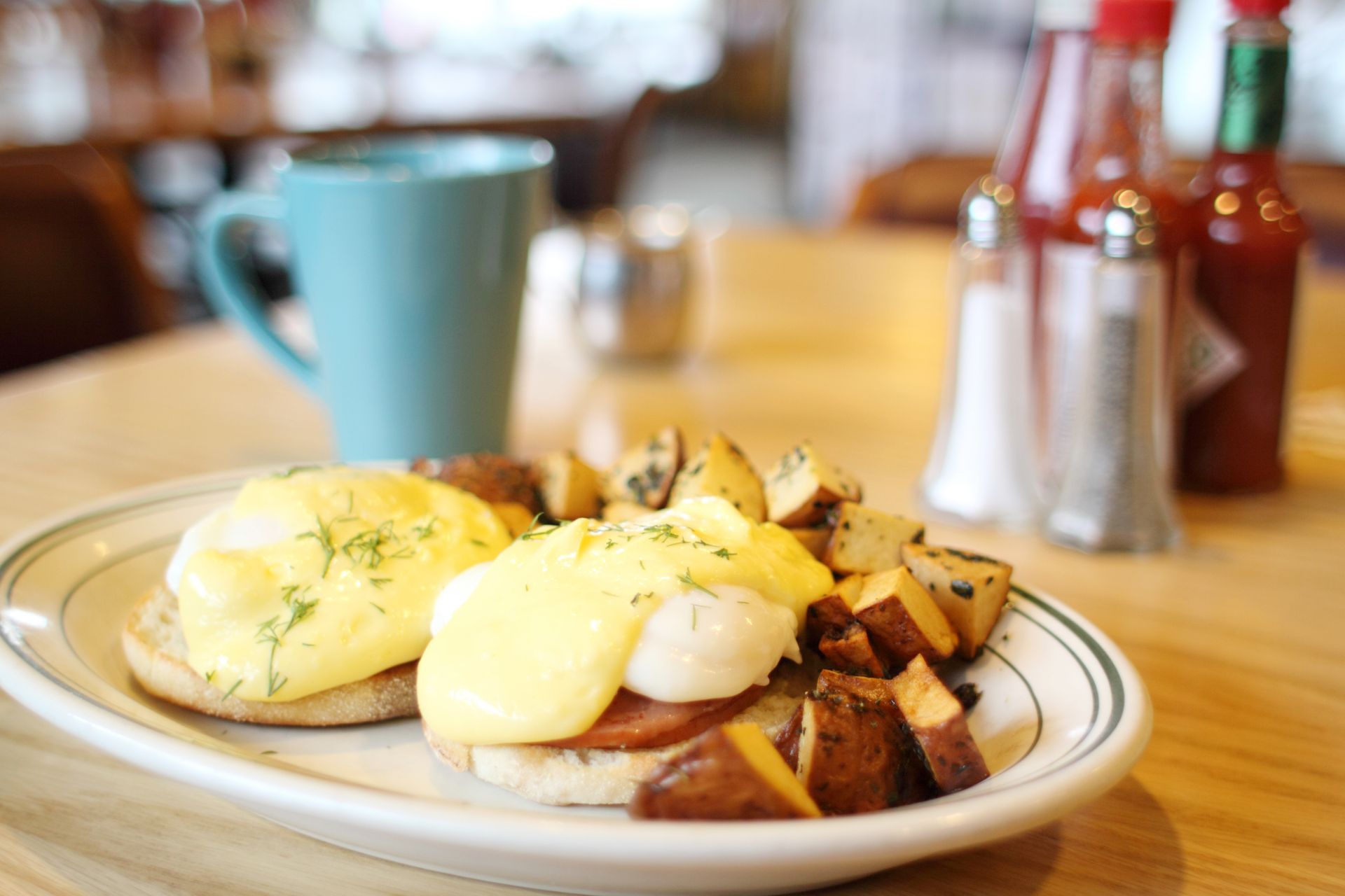 A stack of pancakes with blueberries on a white plate.