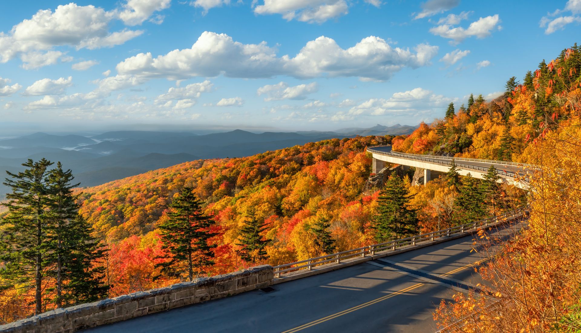 Hiking trail marker nailed to a tree. Silhouette of person with backpack and walking stick.