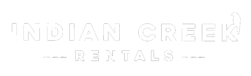 Logo for Indian Creek Rentals. Text is white and has a minimalist aesthetic. A bird icon is to the right of the word 