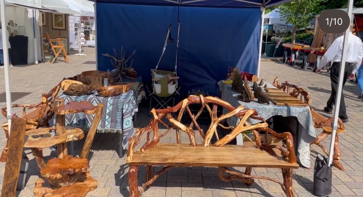 Wooden bowls, containers, and spoons displayed, showcasing handcrafted wood items.
