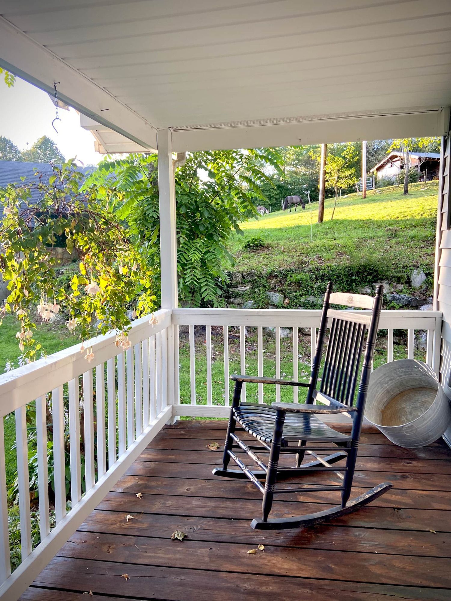 There is a rocking chair on the porch of a house.