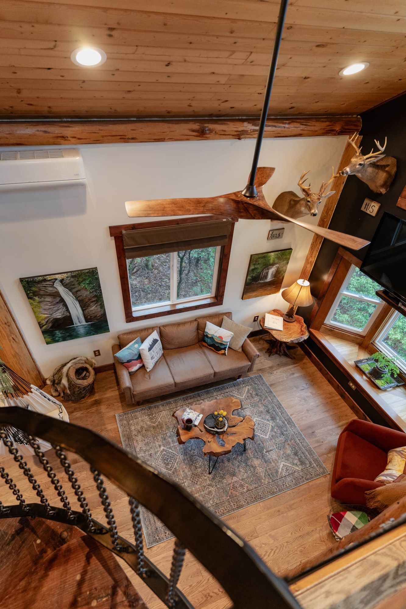An aerial view of a living room with a spiral staircase leading up to it.