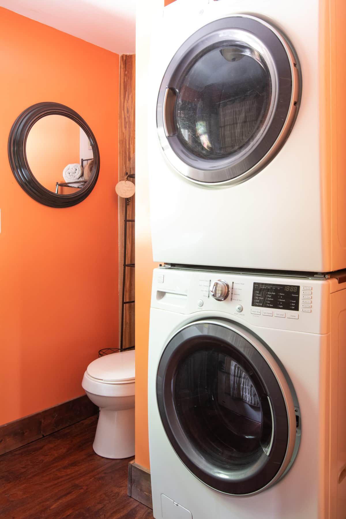 A washer and dryer are stacked on top of each other in a bathroom.