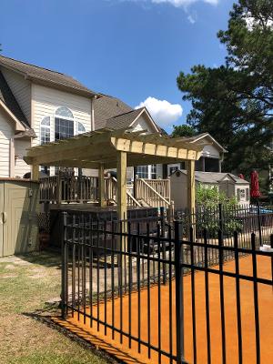 black wrought iron fence with pergola