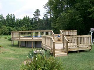 new deck surrounding above ground pool with deck landing