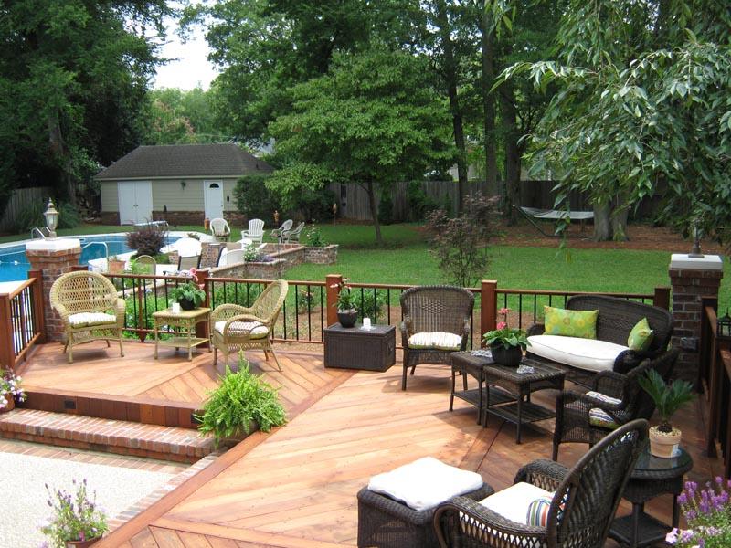 corner of wooden deck surrounding sunken cement patio
