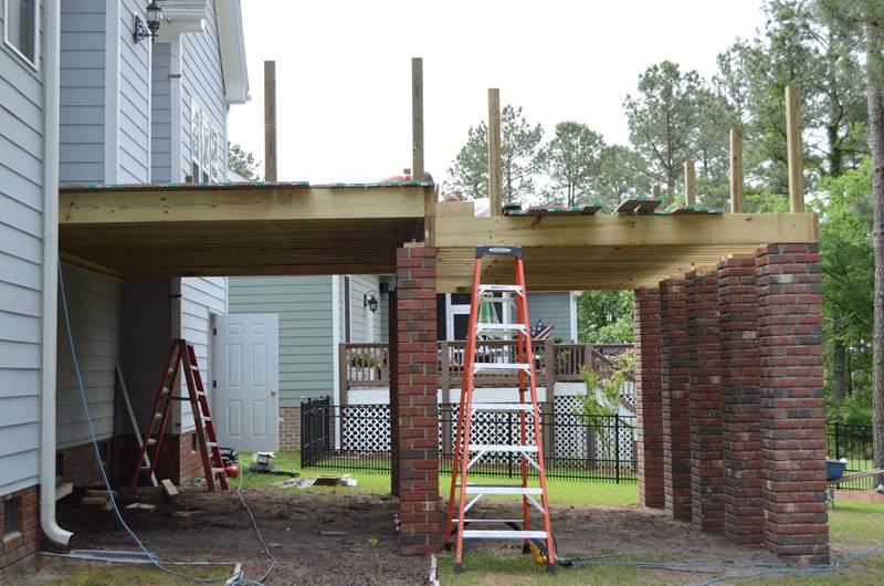 new deck under construction with brick column footers