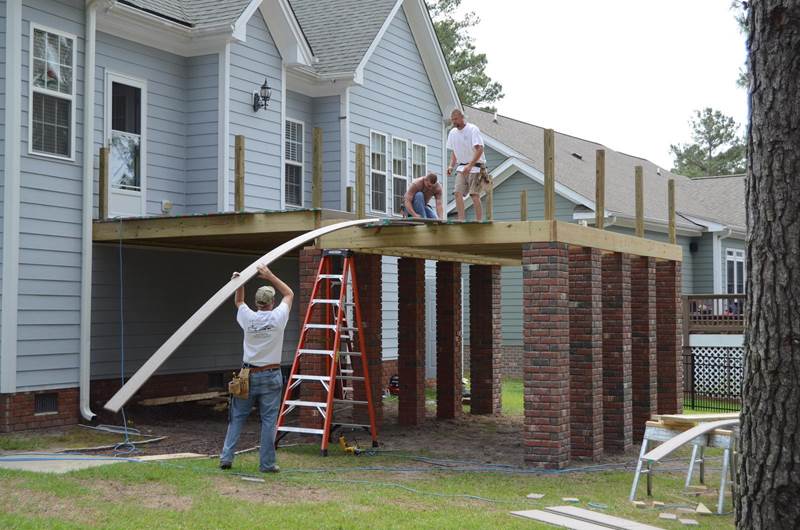 3 construction workers building new deck