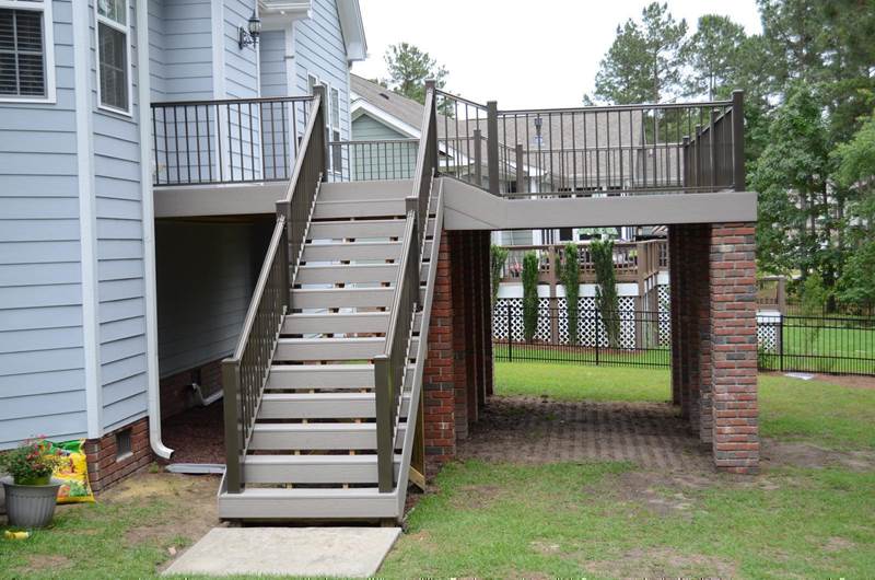 completed deck painted gray with brick footers
