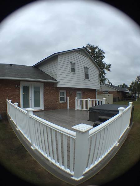 deck with white railing and jacuzzi