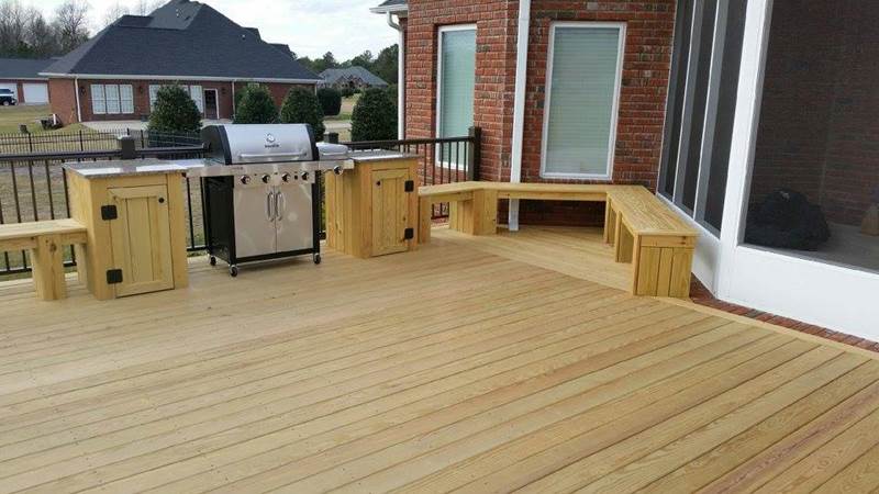 new deck with built in bench seating and grill
