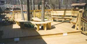 deck with bench seating built around a tree