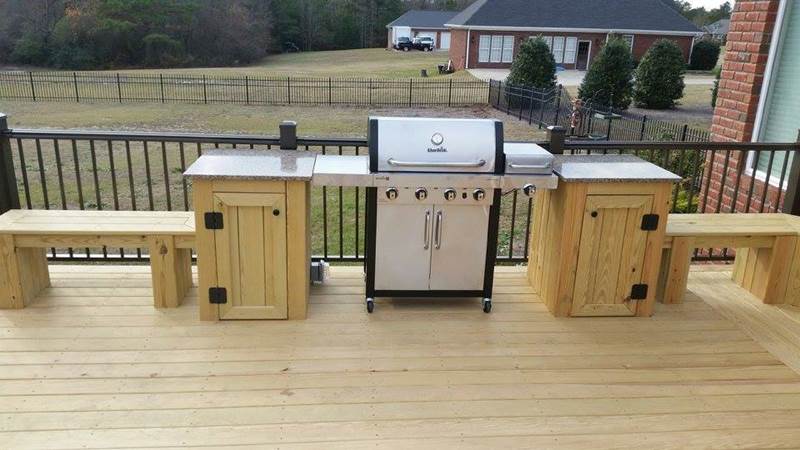 grill with built in cabinets attached to bench seating