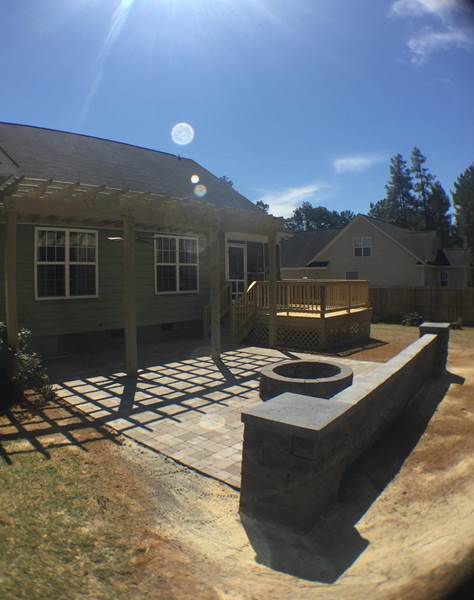 brick patio with pergola and fire pit