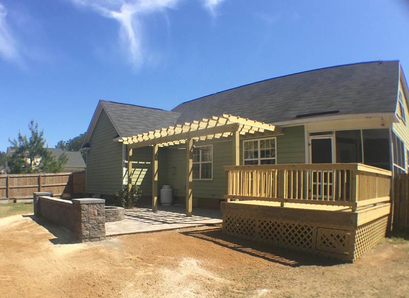 deck off patio with pergola fire pit and seating wall