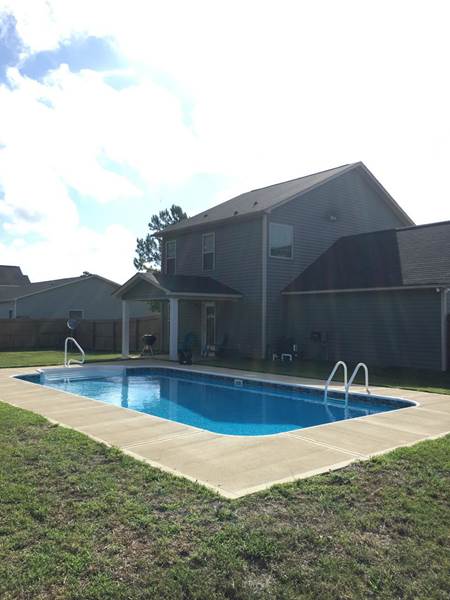 swimming pool with covered patio