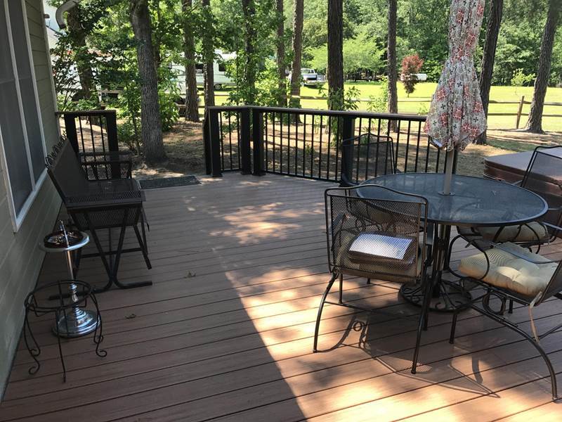deck with patio set and steps leading to yard