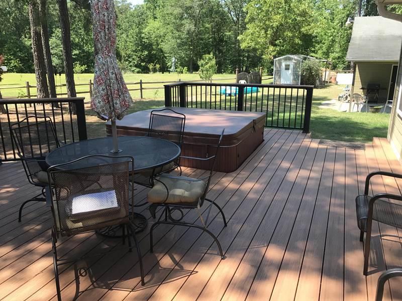 deck with patio set and jacuzzi