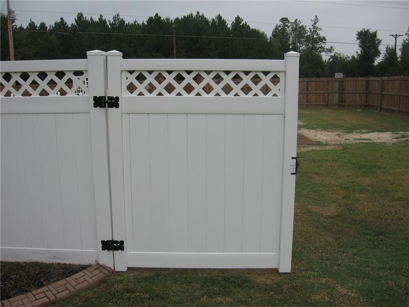 gate on white vinyl board on board fence with lattice