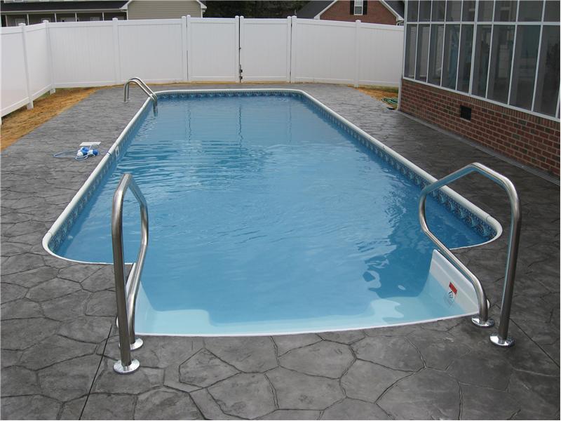 stairs leading into rectagular pool with gray stone patio