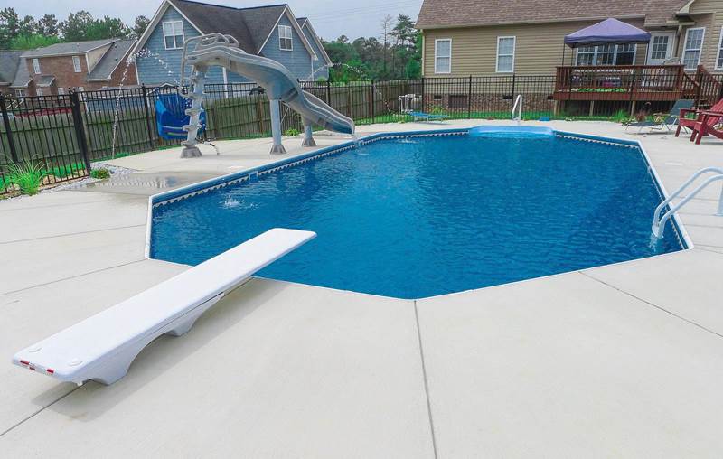 octagon pool with diving board and slide