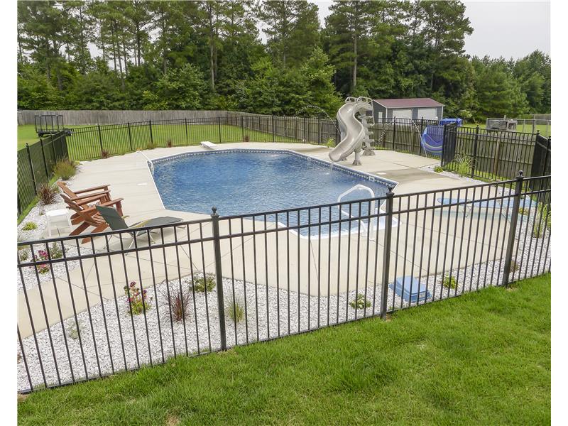 wrought iron fence surrounding pool with slide