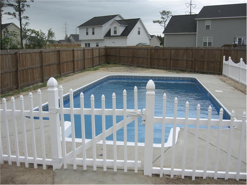 inground pool with picket fence