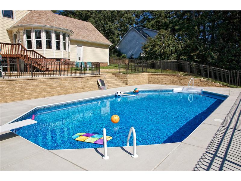 pool with floating toys and top tier of patio