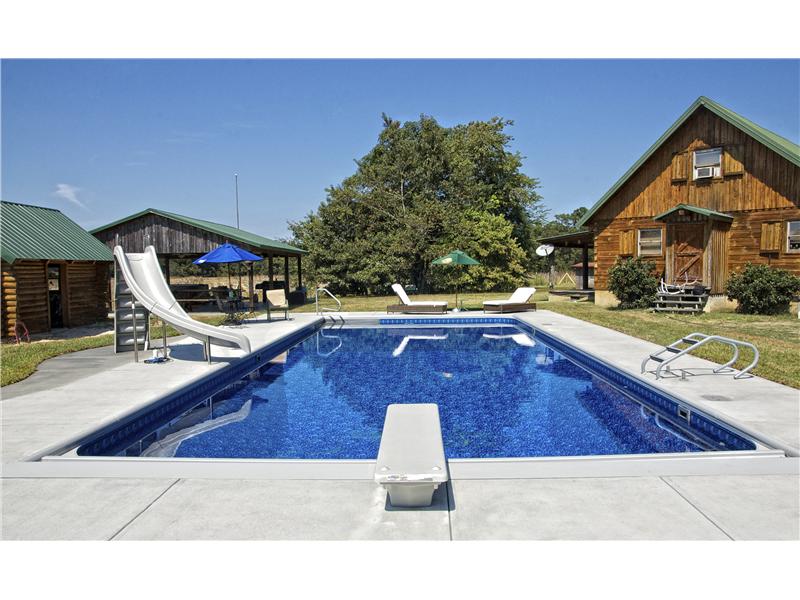 rectangular pool with diving board and slide