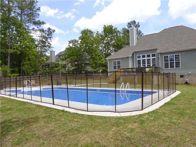 fence surrounding pool and back of house