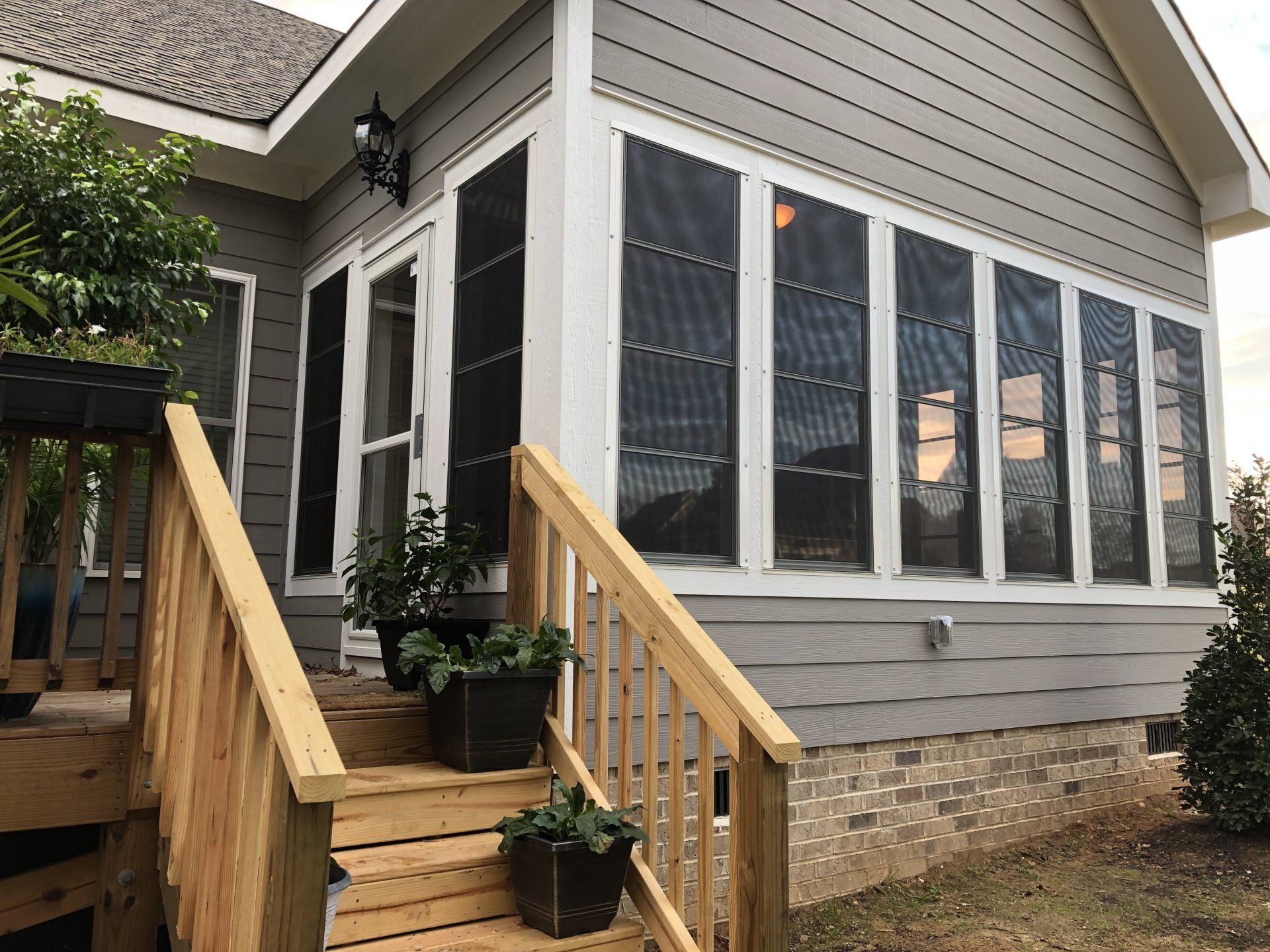 deck stairs leading up to sunroom addition