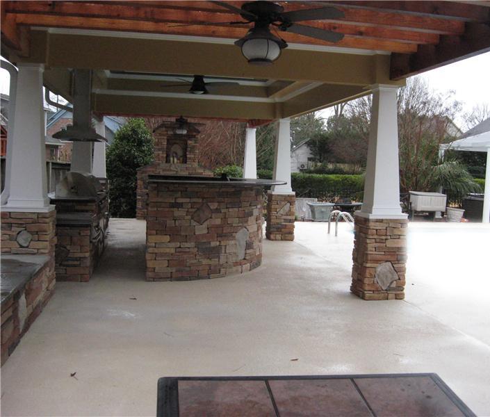side view of covered outdoor kitchen with ceiling fans