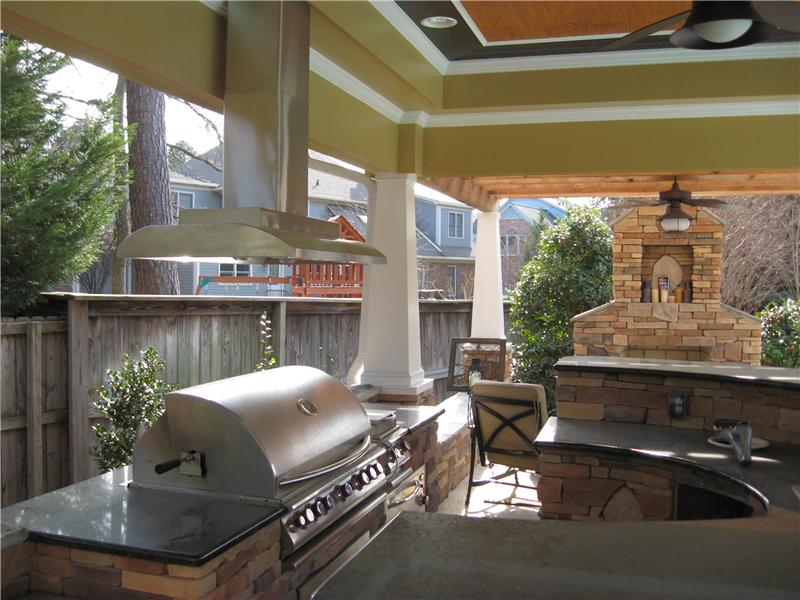 inside view of covered kitchen with brick fireplace