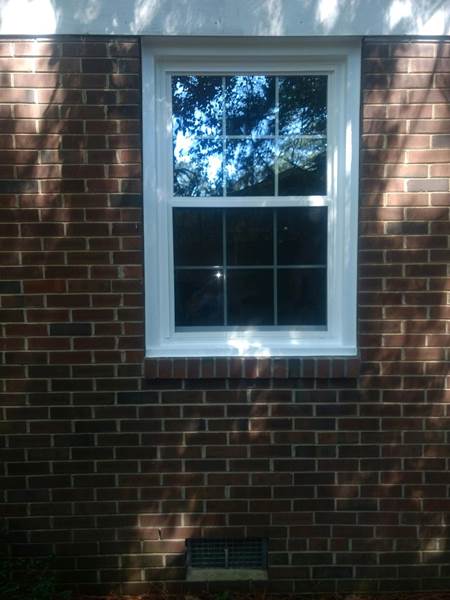 single window no shutters on brick house