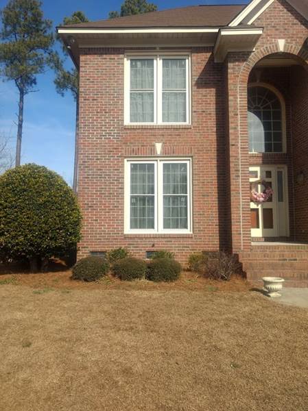 2 double windows and a foyers window on brick house