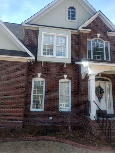 several windows on front of brick house