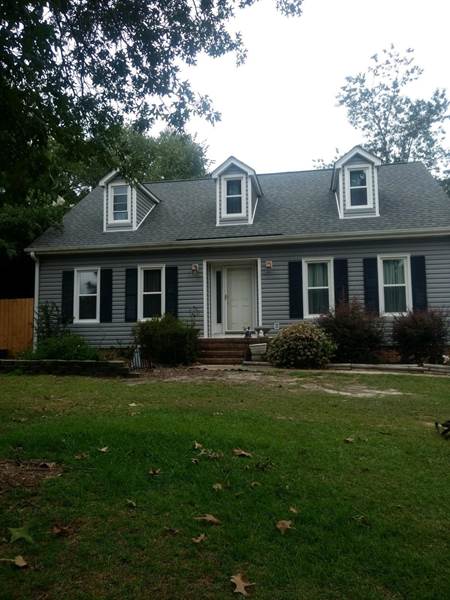 7 windows on front of house with 3 of the windows are dormers