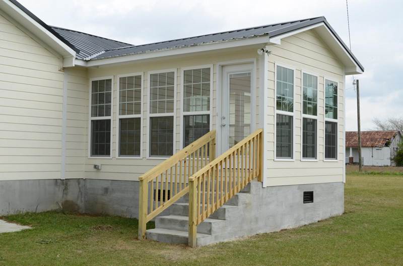 side view of sunroom addition with stairs leading up