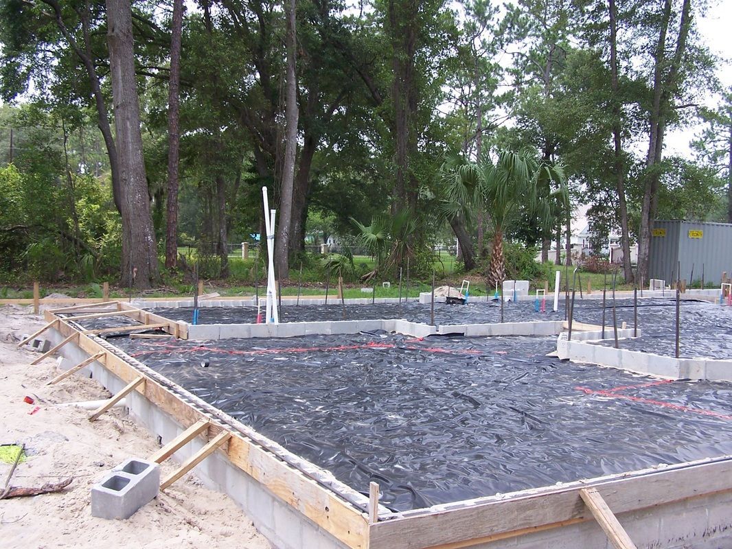 A concrete foundation is being built in the middle of a forest.