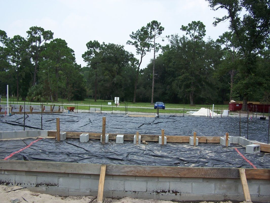 A construction site with a lot of trees in the background