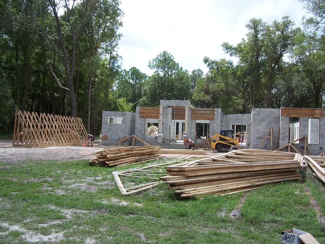 A house is being built with a lot of wood in front of it