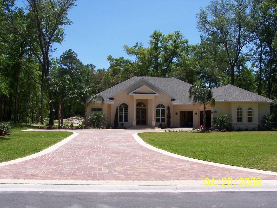 A large house with a driveway leading to it